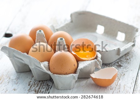 Eggs in a carton on a wooden background