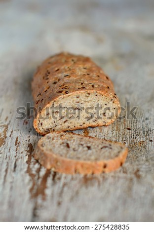 homemade whole wheat bread with flax seeds on wooden surface