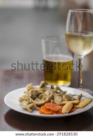 fried anchovies, white wine and beer at a street bar, Seville, Spain