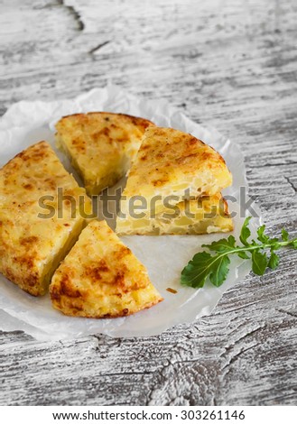potato tortilla on a light wooden background