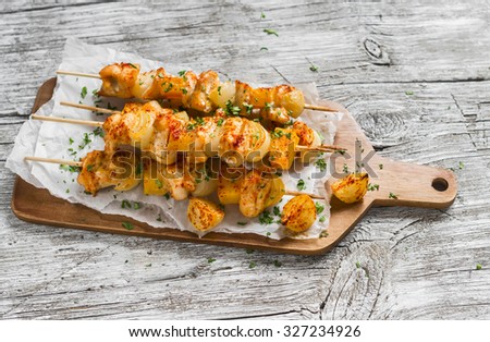 chicken kebab with pumpkin and onions on a light wooden surface. Healthy food
