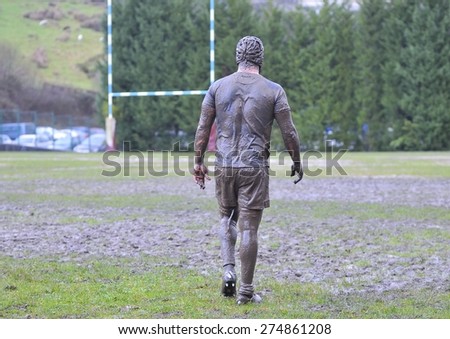 Detail muddy boots in a rugby match.