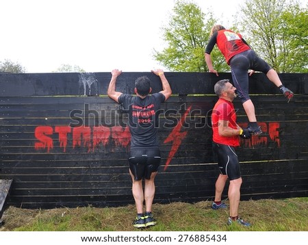 OVIEDO, SPAIN - MAY 9: Storm Race, an extreme obstacle course in May 9, 2015 in Oviedo, Spain. Runners jumping a wooden wall.