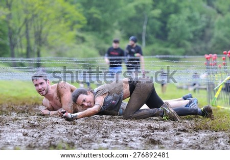 OVIEDO, SPAIN - MAY 9: Storm Race, an extreme obstacle course in May 9, 2015 in Oviedo, Spain. Runners crawled under barbed wire.