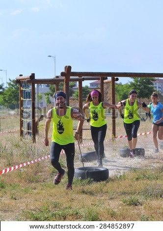 LEON, SPAIN - JUNE 6: Farinato Race, extreme obstacle race in June 6, 2015 in Leon, Spain. People jumping, crawling,passing under a barbed wires or climbing obstacles during extreme obstacle race.