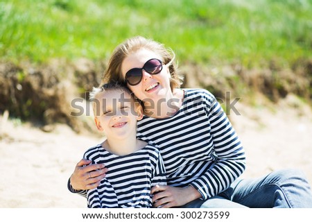 Beautiful woman and her son resting on the beach