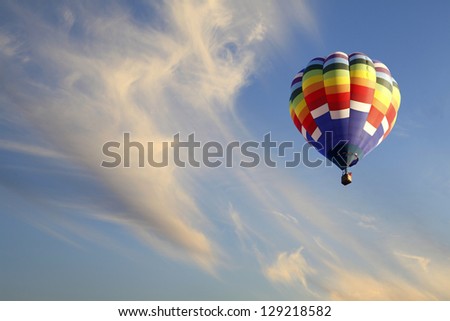 Colorful Hot Air Balloon Ascending into Beautiful Clouds