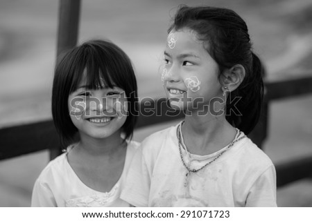 Sangklaburi,Thailand May 31: Unidentified young asian girl smile with thanaka powder on face of this \