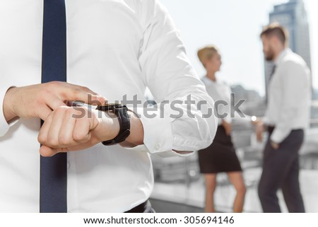 Businessman looks at the clock
