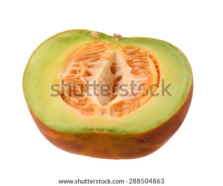 Freshly cut Cantaloupe showing the orange flesh, seeds and green skin on a white background.