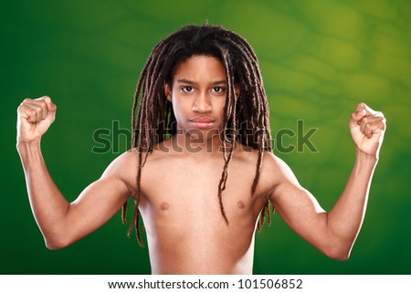 fine art portrait of a rasta kid posing in double biceps position