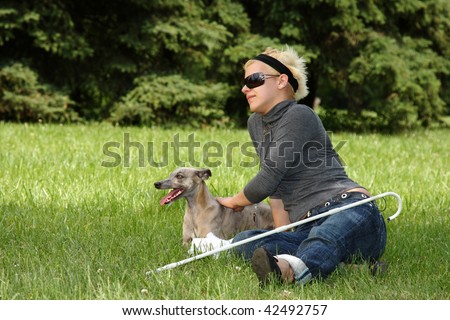 blind woman with her little dog in a park