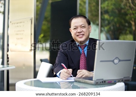 Asian businessman writing business proposal