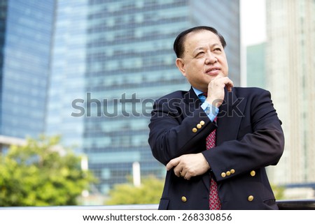 Asian businessman in suit smiling