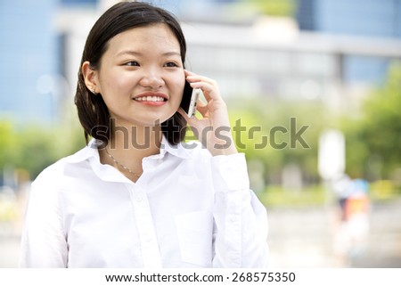 Asian young female executive talking on smart phone