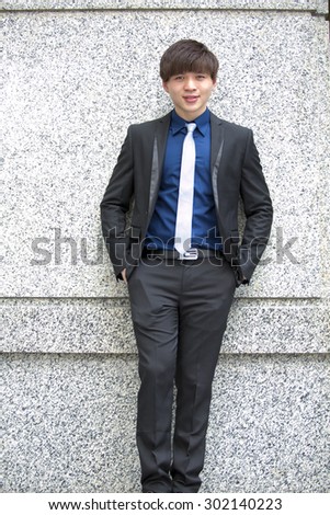 Young Asian male business executive in suit smiling portrait
