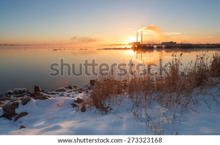 Hot sunset over the thermal power plant in winter