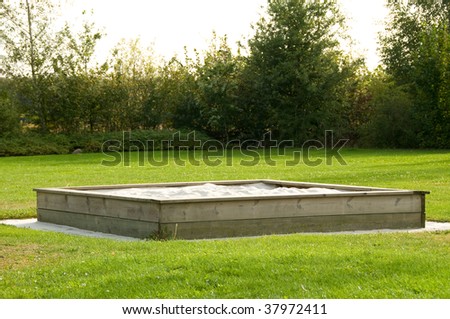 wooden sand box on lawn