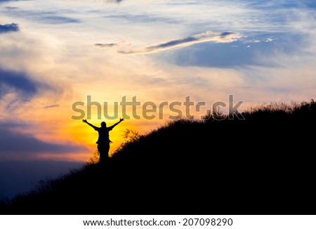Happy hiker in front of sunset