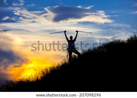 Mountain hiker in front of sunset
