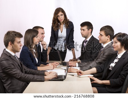Dissatisfied manager. Severe female manager criticizes her team of subordinates.