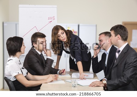Energetic female corporate manager instructs her team