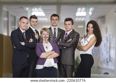 Friendly harmonious business team. Six people dressed in line with business dress code enjoy working together