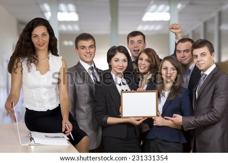 Female business trainer in front of the happy graduates who successfully passed the course