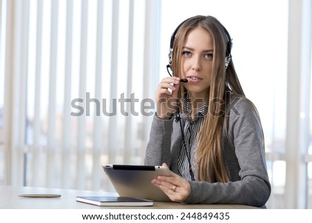 Female customer support officer. Portrait of smiling cheerful customer support phone operator in headset talking to customer