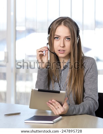 Serious female customer support officer. Portrait of serious customer support phone operator in headset talking to customer