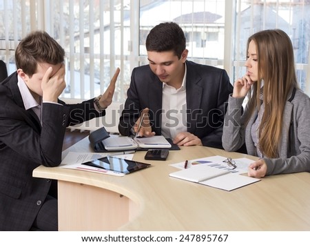 Bored manager. Group of business people on the meeting. Male participant rejects the offer and makes closing his face with the hand