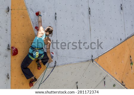 Female sport climber on the climbing wall. National Climbing Championship, Lead climbing qualification round. Dnepropetrovsk, Ukraine, May 22, 2015