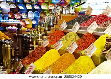 Eastern bazaar - spices, coffee Turks and hand mills. Image market Istanbul large colorful oriental selection of spices on foreground coffee Turks and mills on background with focus on Turks