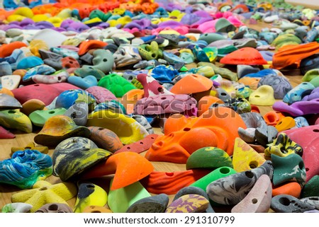 Heap of rock climbing holds. Abstract composition with many large variety of colorful climbing holds for sport gym