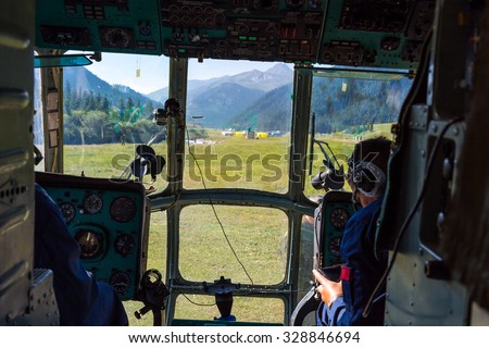 Helicopter Cockpit During Take Off from Landing Camp at Remote Area of Kyrgyzstan Throw Window Pilot Arms