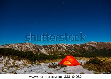 Winter Hiking Bivouac in Mountain Landscape and Night Sky with Many Stars Red Tent and Snowy Terrain