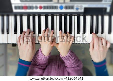 Teamwork Concept Image - Piano Keyboard top View and Hands of Child and Mother playing music