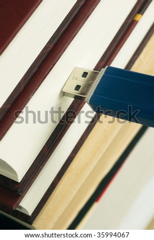 Close-up USB memory stick connected to books
