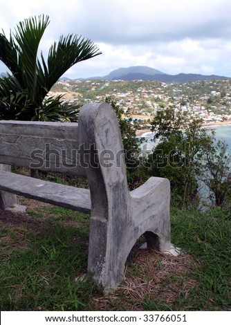 An empty concrete bench overlooking a bay in St. Lucia