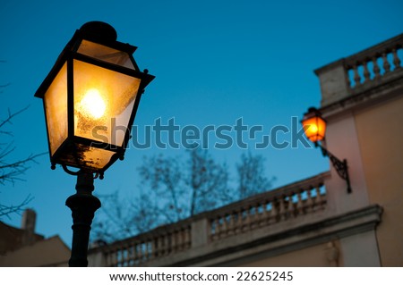 Two street lamps at night
