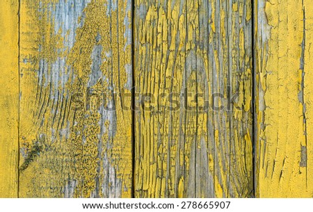 old wooden yellow wall of house. paint began to sour .