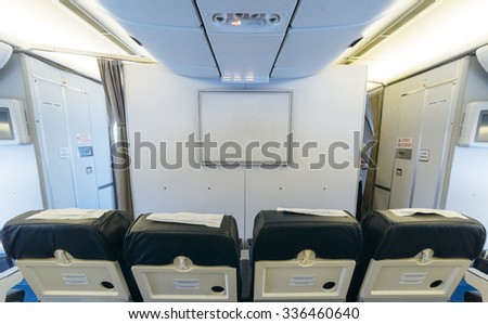 Airplane on the airfield. Inside the cabin . View on the screen from the side of the cabin.