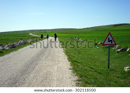 Tourists walking along the road