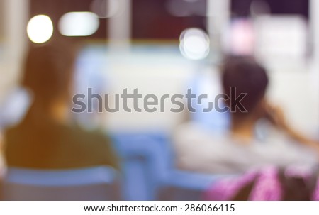 Out of focus Asian girl and young boy was on the phone at bus terminal