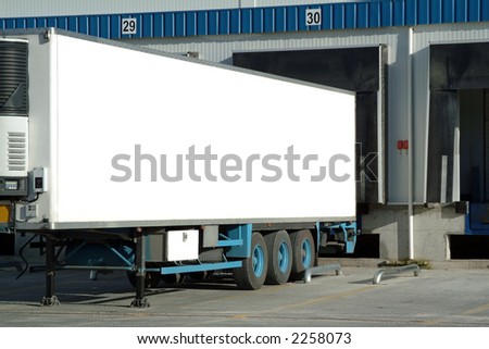 Trailer of truck sitting at a loading dock.