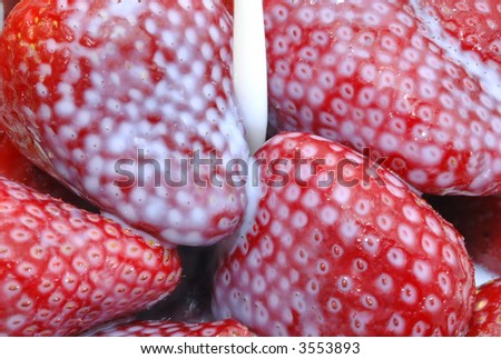 Milk spilling on a delicious  fresh strawberry