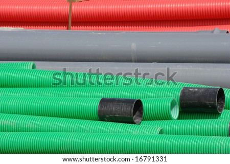 Colorful flexible pipes stacked in construction site