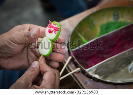 Making Candy Sugar Sculpture in a form of rosette. It is a kind of Thai ancient dessert