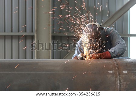 Welder worker is welding a big valve body