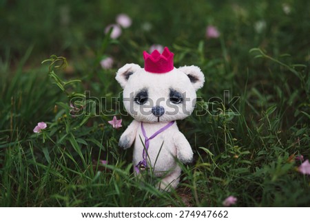 Pink artist Teddy bear in flower garden